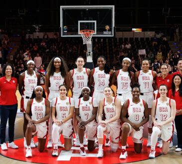 The United States women's basketball team poses for a team photo at center court before a World Cup game.