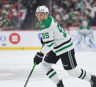 Stars defenseman Thomas Harley skates up ice with the puck on his stick against the Wild.