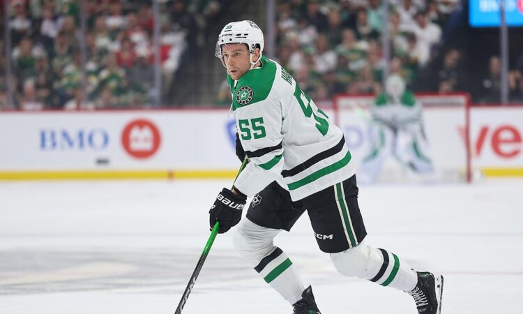 Stars defenseman Thomas Harley skates up ice with the puck on his stick against the Wild.