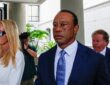 Tiger Woods in a dark suit walks from a courthouse alongside Vanessa Trump after a court appearance.