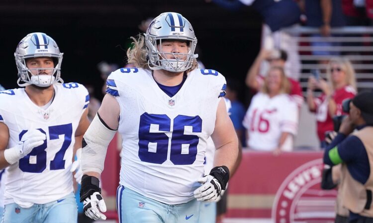 Dallas Cowboys guard T.J. Bass jogs onto the field in uniform before a game against San Francisco.