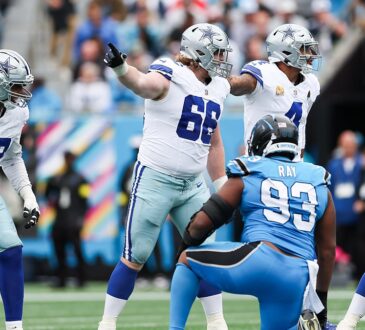 Dallas Cowboys guard T.J. Bass points and calls out an assignment at the line of scrimmage against the Panthers.