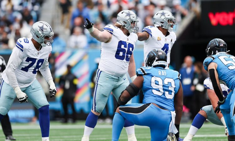 Dallas Cowboys guard T.J. Bass points and calls out an assignment at the line of scrimmage against the Panthers.