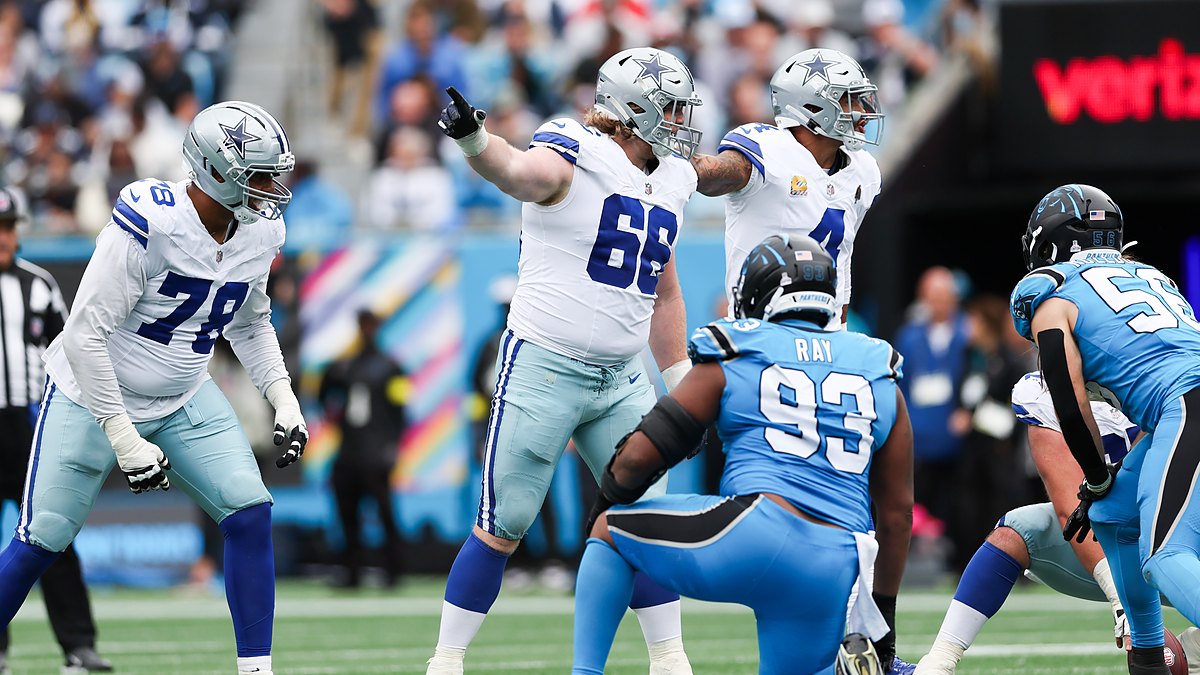 Dallas Cowboys guard T.J. Bass points and calls out an assignment at the line of scrimmage against the Panthers.