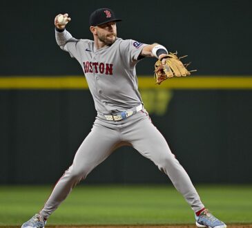 Boston Red Sox shortstop Trevor Story sets his feet and throws to first base during a game at Globe Life Field.