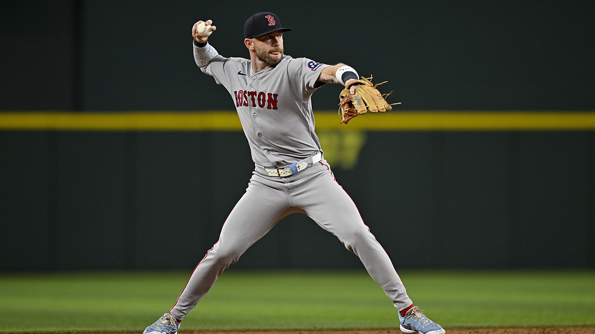 Boston Red Sox shortstop Trevor Story sets his feet and throws to first base during a game at Globe Life Field.