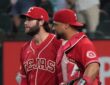 Texas Rangers pitcher Trevor Williams and catcher Elias Díaz walk off the field side by side after a win.