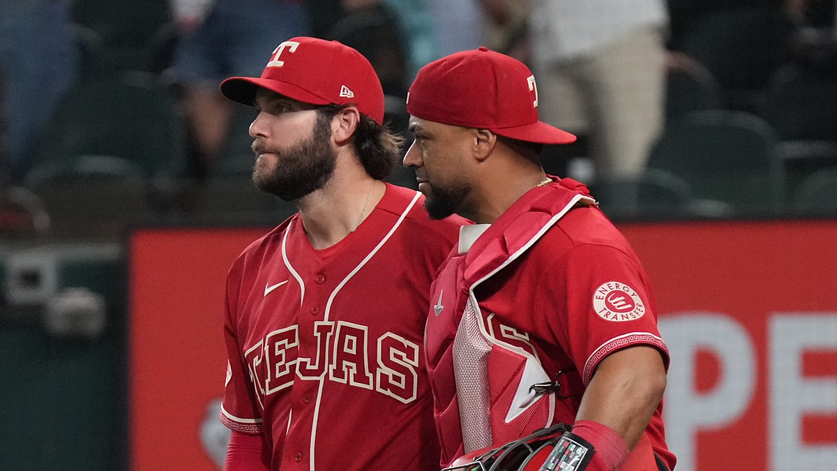 Texas Rangers pitcher Trevor Williams and catcher Elias Díaz walk off the field side by side after a win.