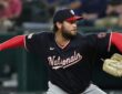 Washington Nationals pitcher Trevor Williams reaches back to deliver in his navy road uniform at Globe Life Field.