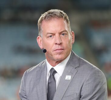 Troy Aikman wears a headset microphone at the broadcast position before the Bengals and Jaguars game.