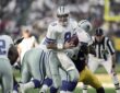 Dallas Cowboys quarterback Troy Aikman turns with the ball to hand off to running back Emmitt Smith against the Steelers.
