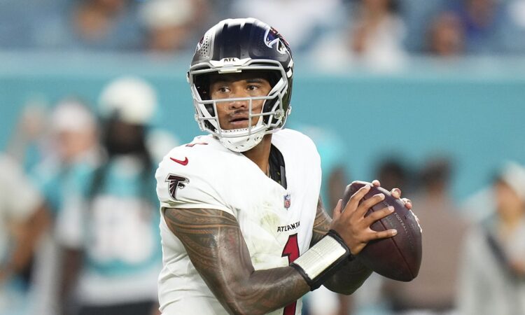 Atlanta Falcons quarterback Tua Tagovailoa holds the ball in both hands as he sets up to throw.