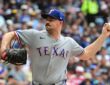 Texas Rangers left-hander Tyler Alexander, No. 13, comes set to deliver a pitch.