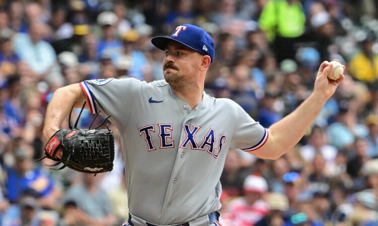 Texas Rangers left-hander Tyler Alexander, No. 13, comes set to deliver a pitch.