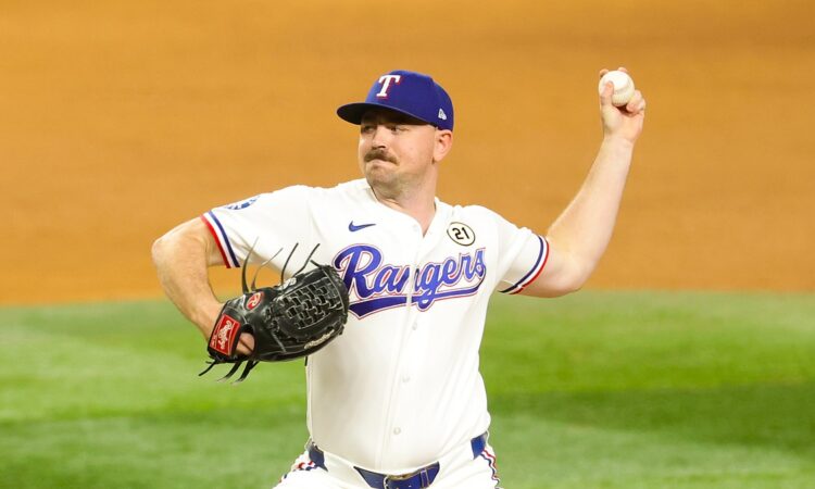 Rangers pitcher Tyler Alexander raises the ball behind him as he drives toward the plate.