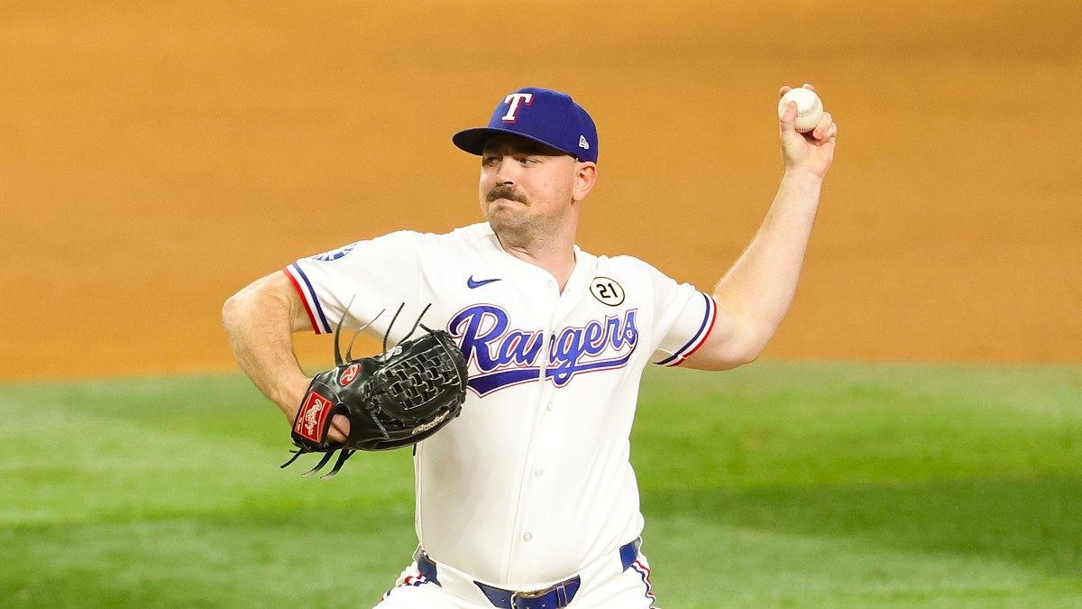 Rangers pitcher Tyler Alexander raises the ball behind him as he drives toward the plate.