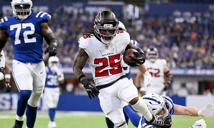 Falcons running back Tyler Goodson breaks past a diving Colts defender on his way into the end zone.