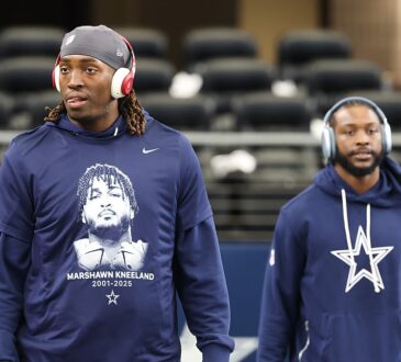 A Dallas Cowboys player in a memorial shirt honoring Marshawn Kneeland walks the field before the game against the Eagles.