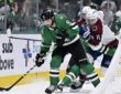 Dallas Stars center Tyler Seguin shields the puck near the net as Colorado's Brock Nelson pressures him.