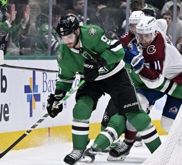 Dallas Stars center Tyler Seguin shields the puck near the net as Colorado's Brock Nelson pressures him.