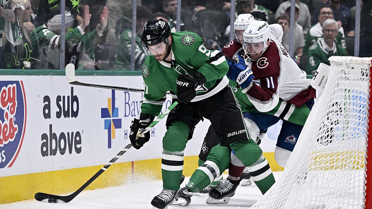 Dallas Stars center Tyler Seguin shields the puck near the net as Colorado's Brock Nelson pressures him.