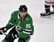 Dallas Stars center Tyler Seguin carries his stick in one hand as he skates up ice against the Washington Capitals.