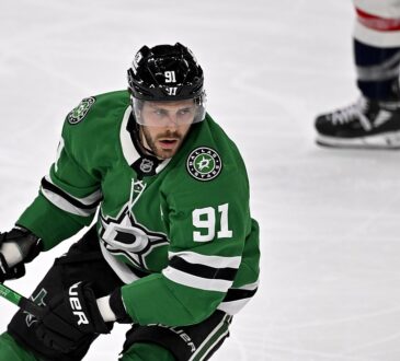 Dallas Stars center Tyler Seguin carries his stick in one hand as he skates up ice against the Washington Capitals.