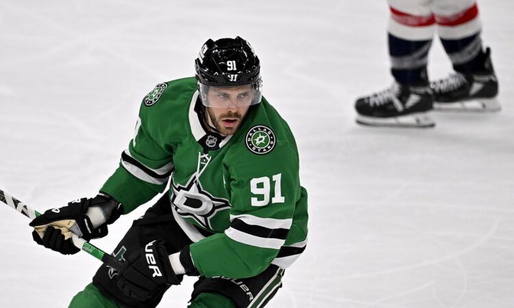 Dallas Stars center Tyler Seguin carries his stick in one hand as he skates up ice against the Washington Capitals.