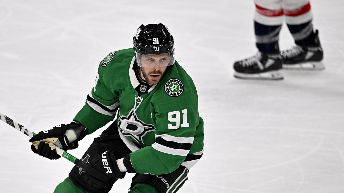 Dallas Stars center Tyler Seguin carries his stick in one hand as he skates up ice against the Washington Capitals.