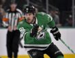 Dallas Stars center Tyler Seguin skates with his stick in one hand during a game against the Los Angeles Kings.