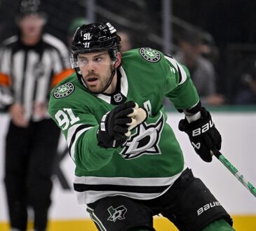 Dallas Stars center Tyler Seguin skates with his stick in one hand during a game against the Los Angeles Kings.