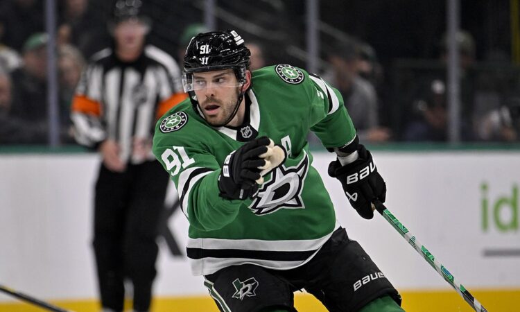 Dallas Stars center Tyler Seguin skates with his stick in one hand during a game against the Los Angeles Kings.