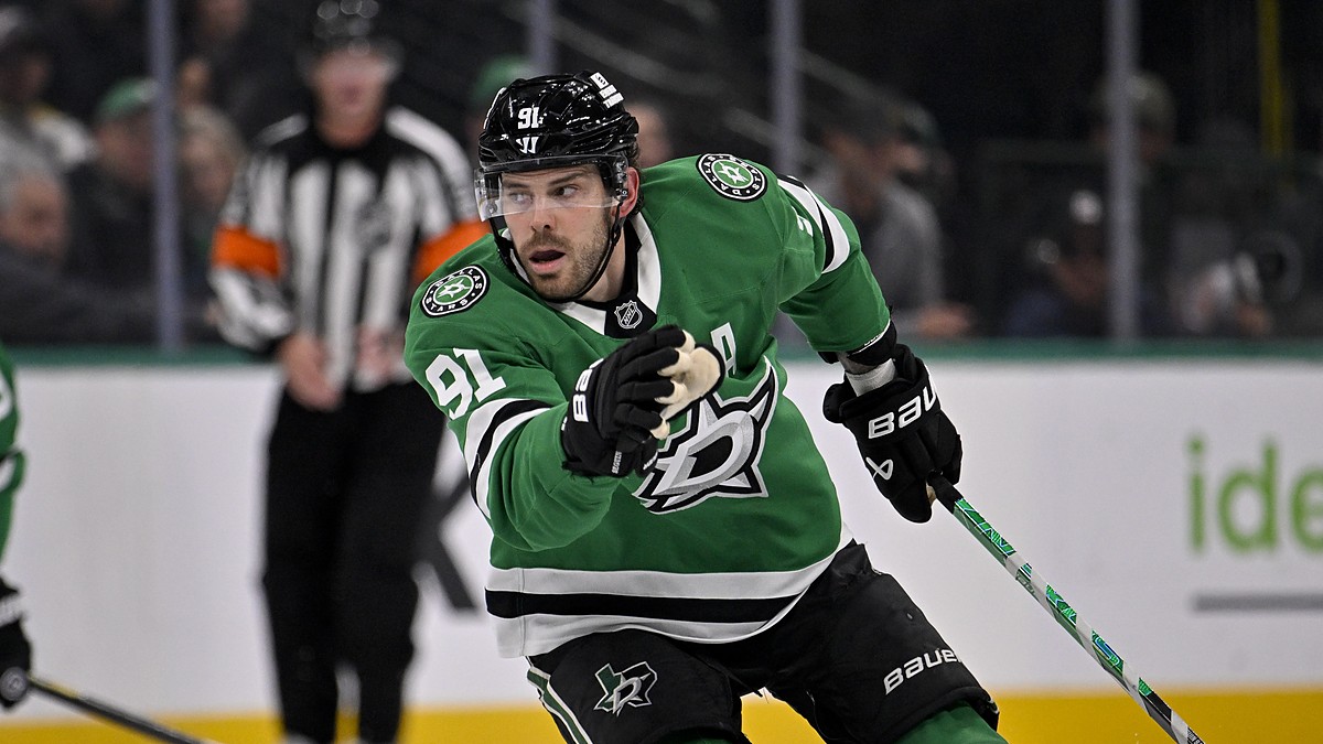 Dallas Stars center Tyler Seguin skates with his stick in one hand during a game against the Los Angeles Kings.