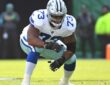 Dallas Cowboys offensive lineman Tyler Smith crouches in his stance at the line of scrimmage against the Eagles.