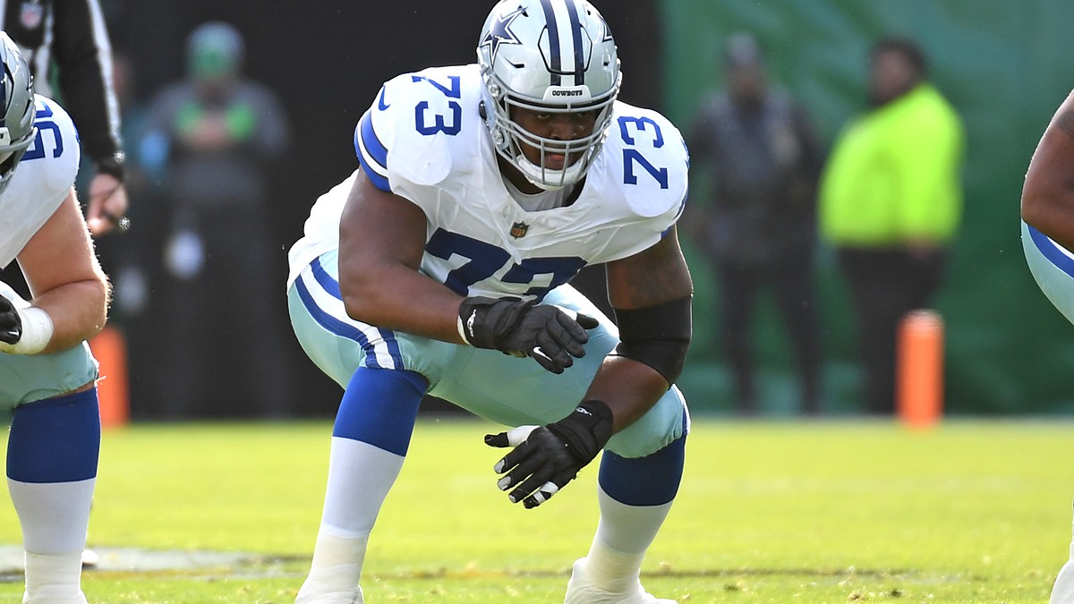 Dallas Cowboys offensive lineman Tyler Smith crouches in his stance at the line of scrimmage against the Eagles.