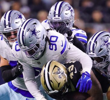 Dallas Cowboys linebacker Tyrus Wheat wraps up New Orleans Saints running back CJ Donaldson as teammates converge.