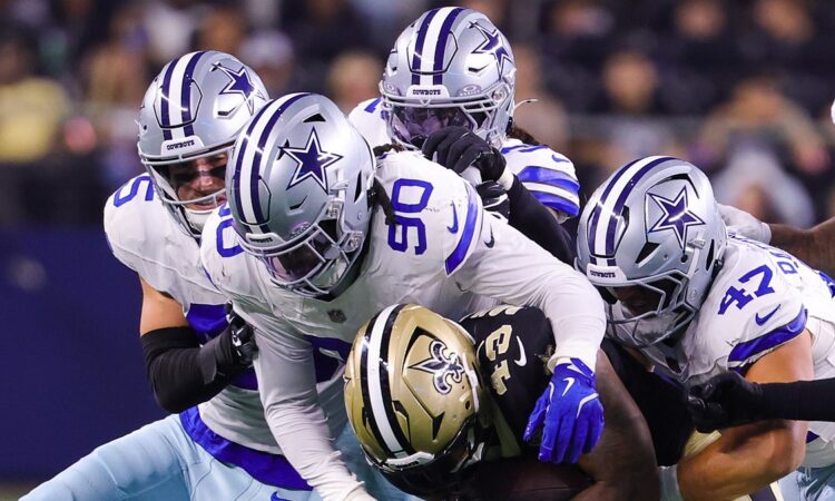 Dallas Cowboys linebacker Tyrus Wheat wraps up New Orleans Saints running back CJ Donaldson as teammates converge.