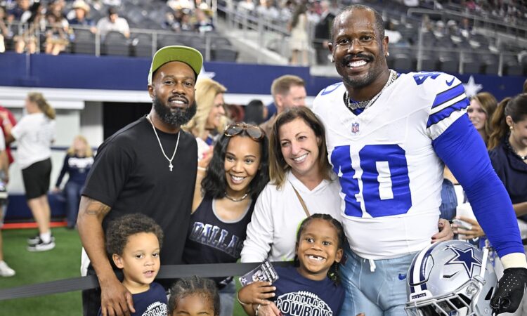 Dallas Cowboys linebacker Von Miller poses with his family on the field before a game at AT&T Stadium.