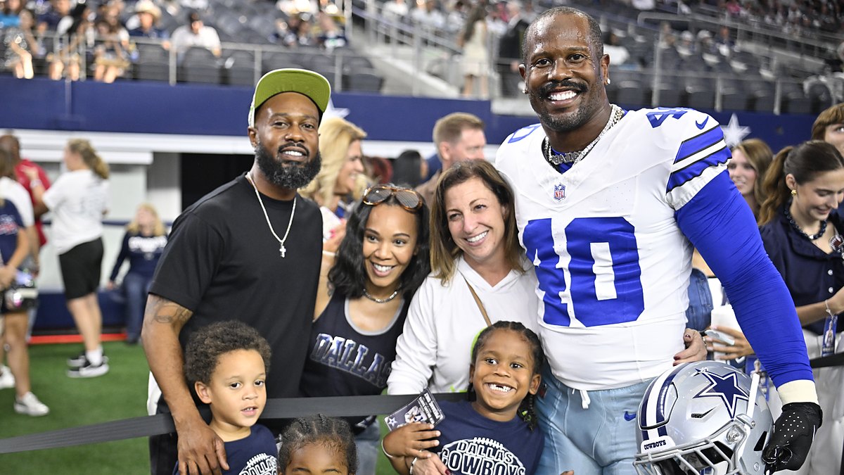 Dallas Cowboys linebacker Von Miller poses with his family on the field before a game at AT&T Stadium.