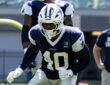 Dallas Cowboys outside linebacker Von Miller drops into a stance in a practice jersey during a team workout.