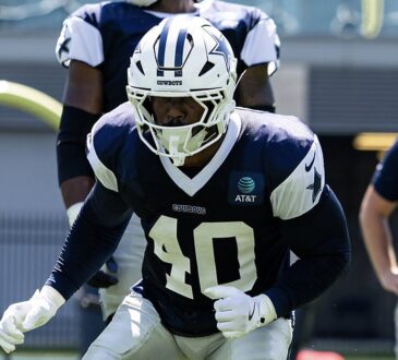 Dallas Cowboys outside linebacker Von Miller drops into a stance in a practice jersey during a team workout.