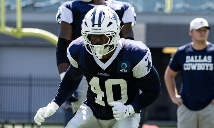 Dallas Cowboys outside linebacker Von Miller drops into a stance in a practice jersey during a team workout.
