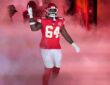 Kansas City Chiefs offensive tackle Wanya Morris raises a hand as he is introduced through smoke at Arrowhead Stadium.