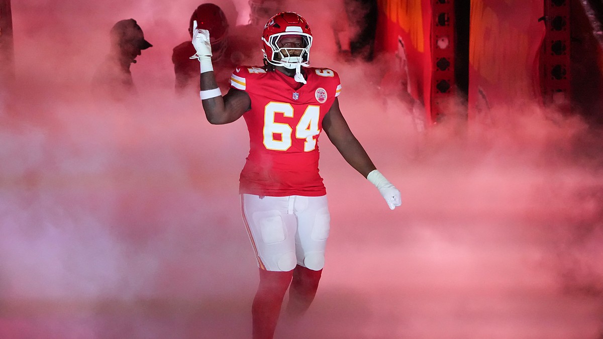 Kansas City Chiefs offensive tackle Wanya Morris raises a hand as he is introduced through smoke at Arrowhead Stadium.