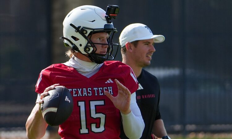 Texas Tech quarterback Will Hammond winds up to throw at practice as offensive coordinator Mack Leftwich watches.