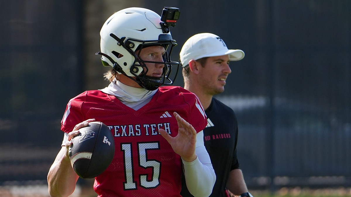 Texas Tech quarterback Will Hammond winds up to throw at practice as offensive coordinator Mack Leftwich watches.