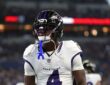 Baltimore Ravens wide receiver Xavien Flowers stands in the end zone with his mouthguard hanging from his face mask.