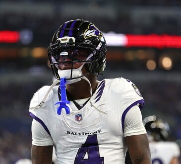 Baltimore Ravens wide receiver Xavien Flowers stands in the end zone with his mouthguard hanging from his face mask.