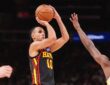 Atlanta Hawks forward Zaccharie Risacher rises for a jump shot with a Golden State defender contesting.
