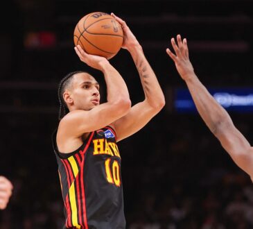 Atlanta Hawks forward Zaccharie Risacher rises for a jump shot with a Golden State defender contesting.